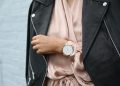 Stylish woman in a leather jacket showcasing an elegant wristwatch, perfect for fashion-forward individuals.