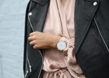 Stylish woman in a leather jacket showcasing an elegant wristwatch, perfect for fashion-forward individuals.