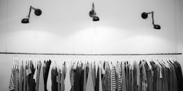 Minimalist black and white clothing display in a stylish boutique setting.